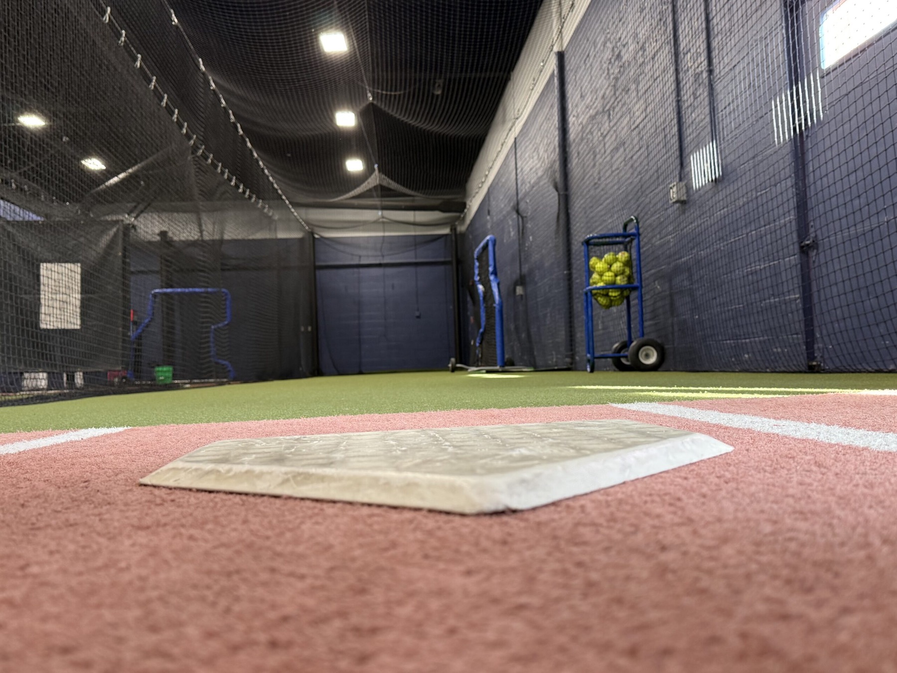 Turf lane and home plate inside the @BAT Elite indoor training facility